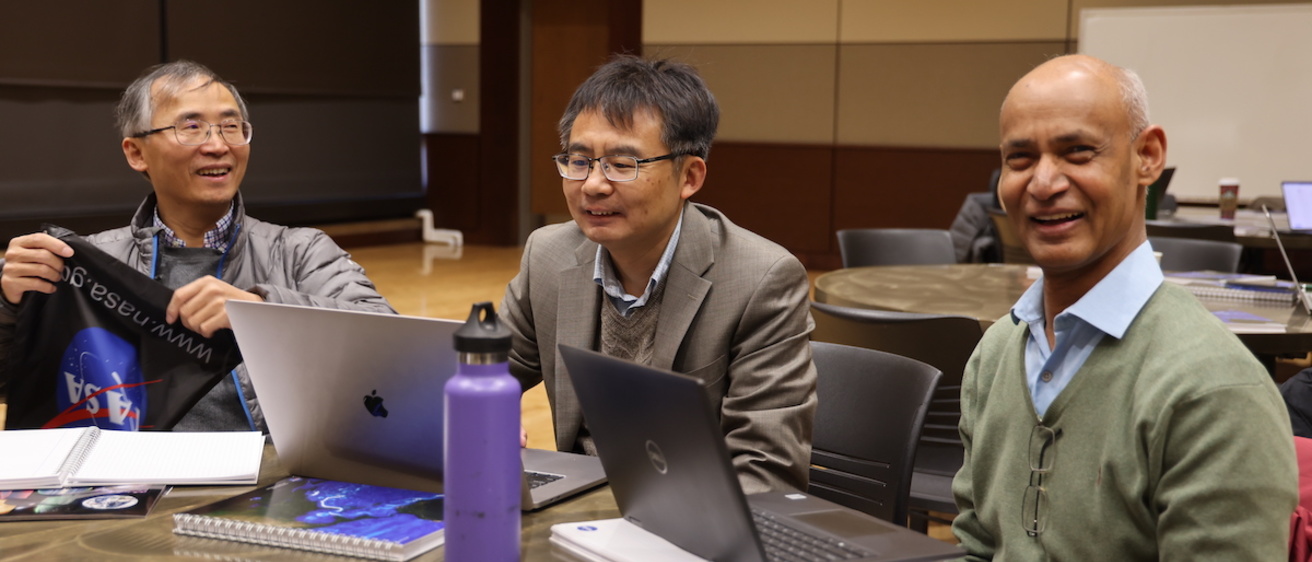 Three people at a table in a meeting room